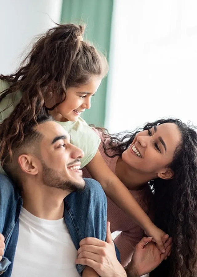 Happy family enjoying quality time in a bright, cozy living room.