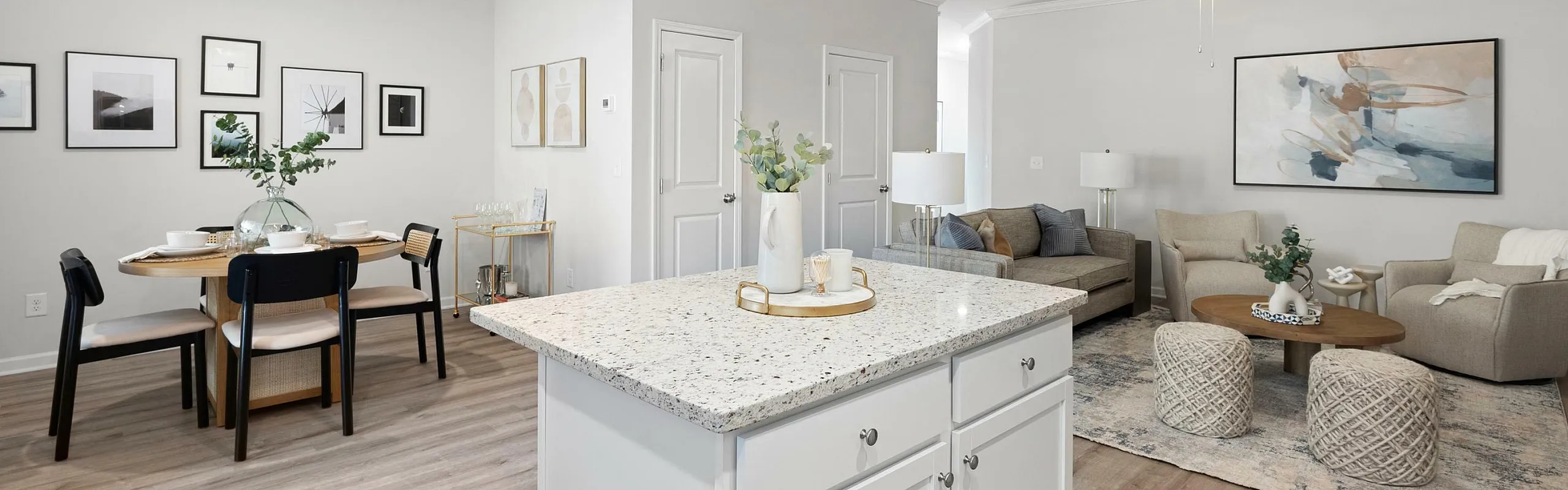 Modern open-concept living area with elegant dining space, cozy seating, and a stylish kitchen island.