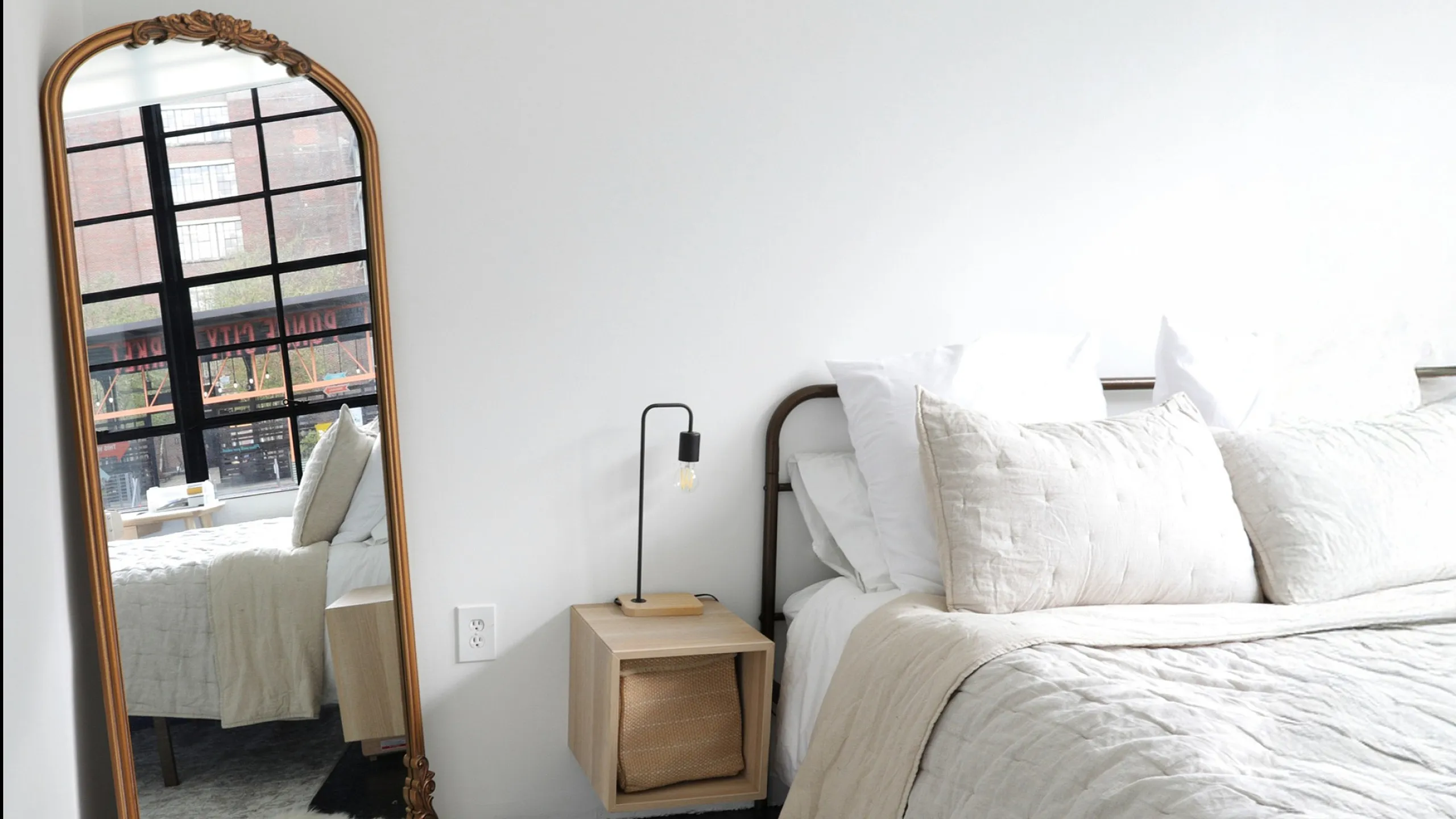 1 bed factory windows on beltline with mirror and beige bed