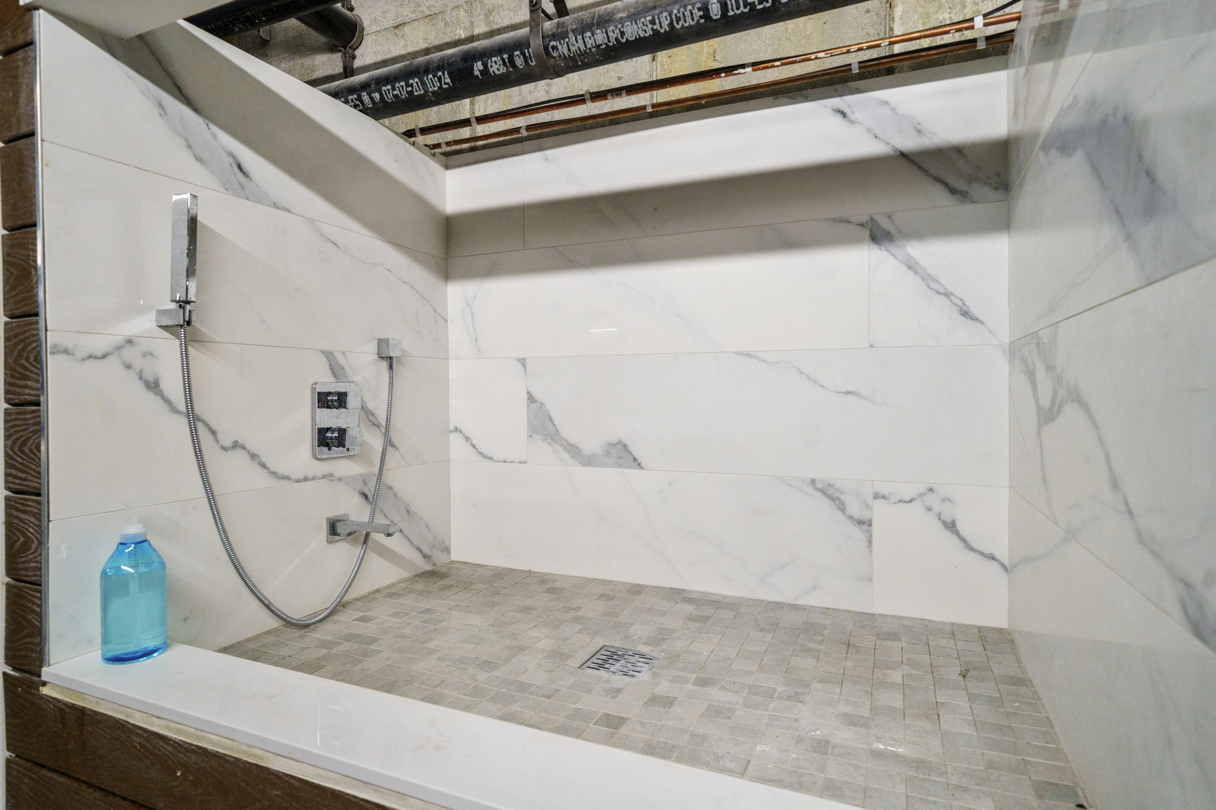 Luxurious marble shower featuring elegant wall tiles and sleek, modern fixtures for a spa-like experience.