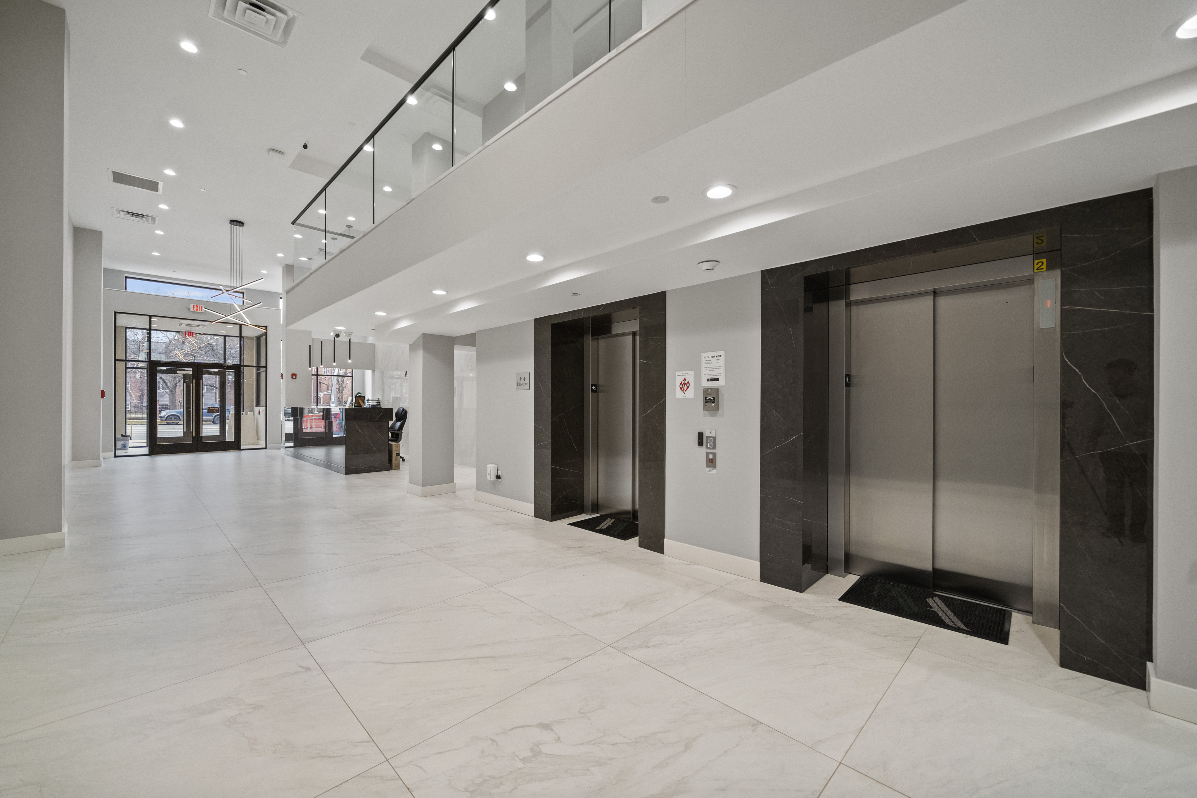 Elegant apartment lobby featuring sleek elevators, modern lighting, and a spacious, bright atmosphere.