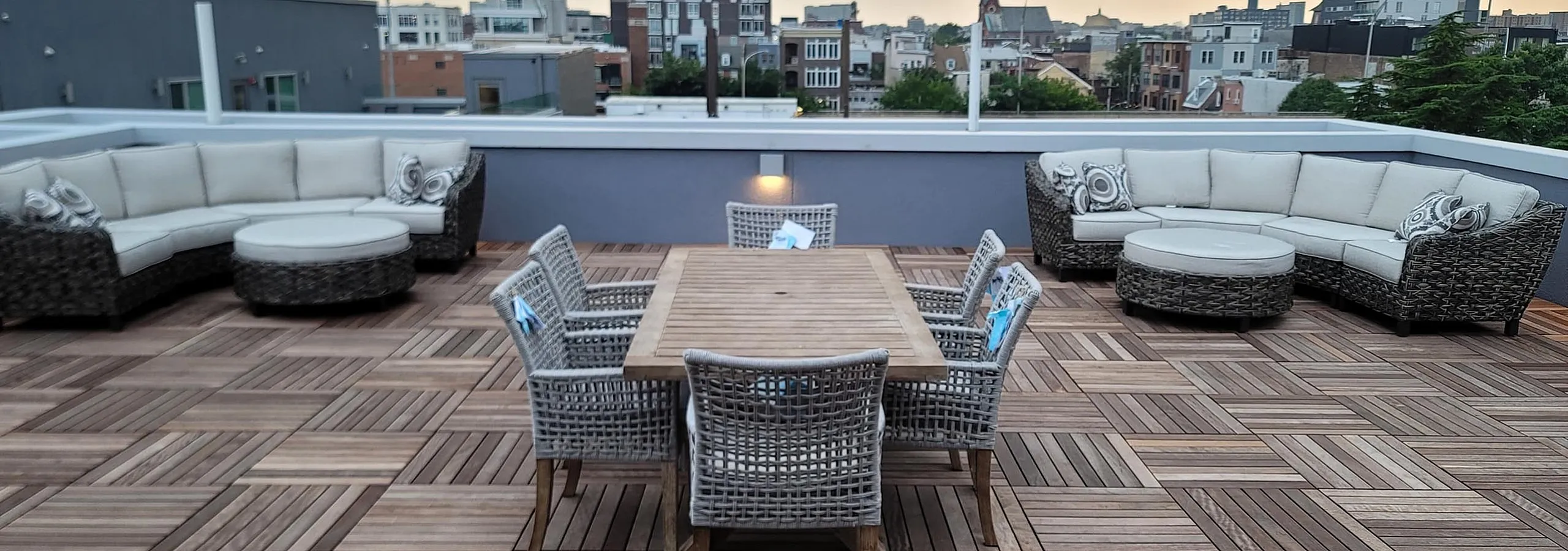 Chic rooftop terrace with stylish wicker seating and city skyline views, perfect for entertaining.