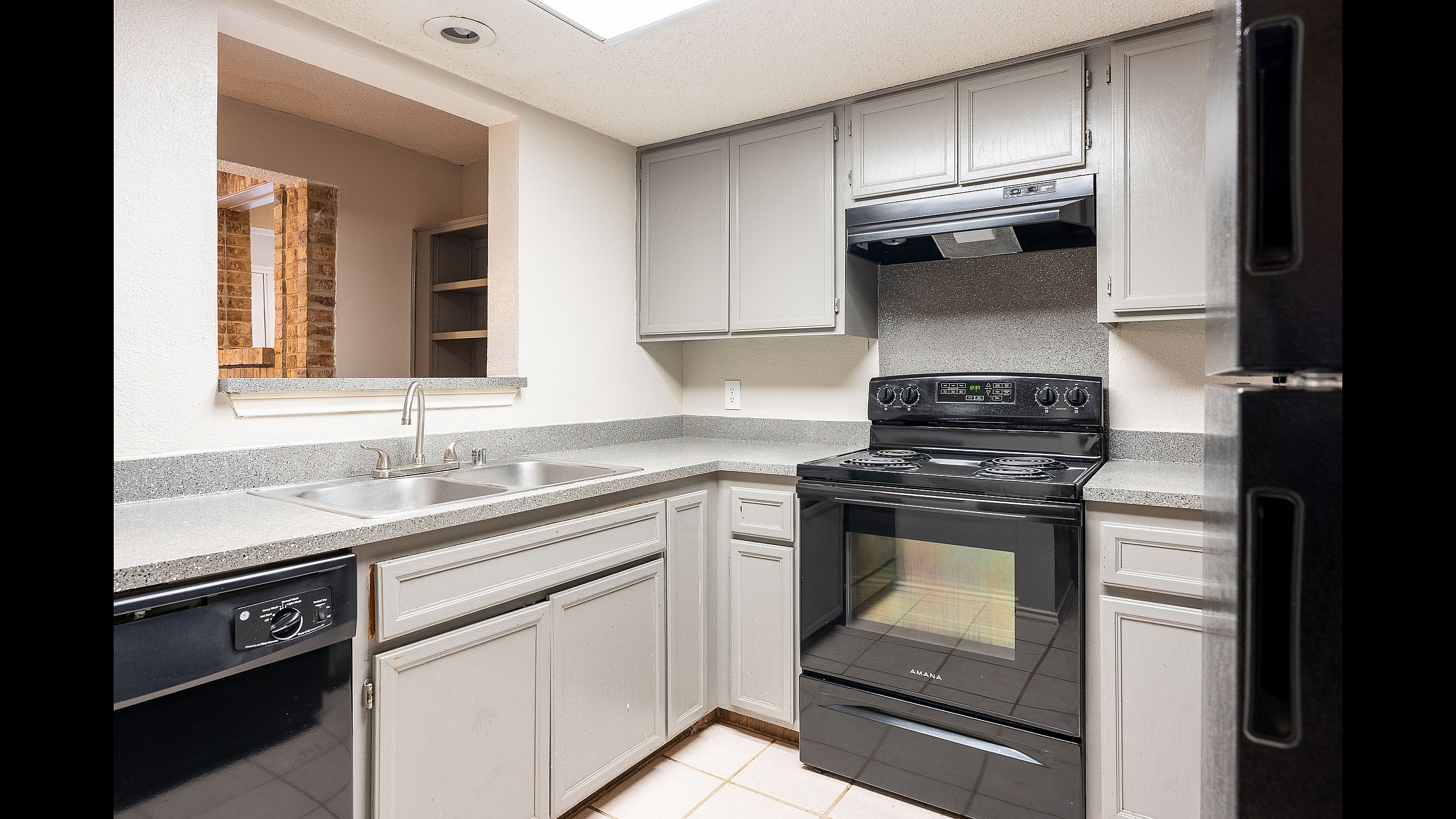 Charming kitchen featuring sleek countertops, modern appliances, and ample cabinetry for an elegant cooking experience.