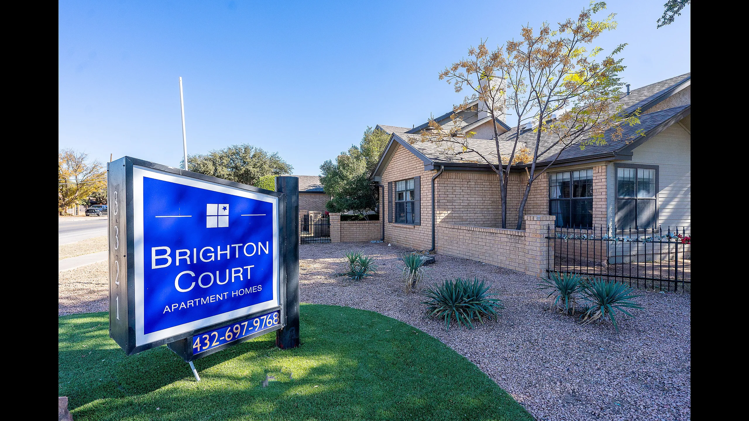 Charming Brighton Court apartment exterior featuring well-maintained landscaping and welcoming ambiance.