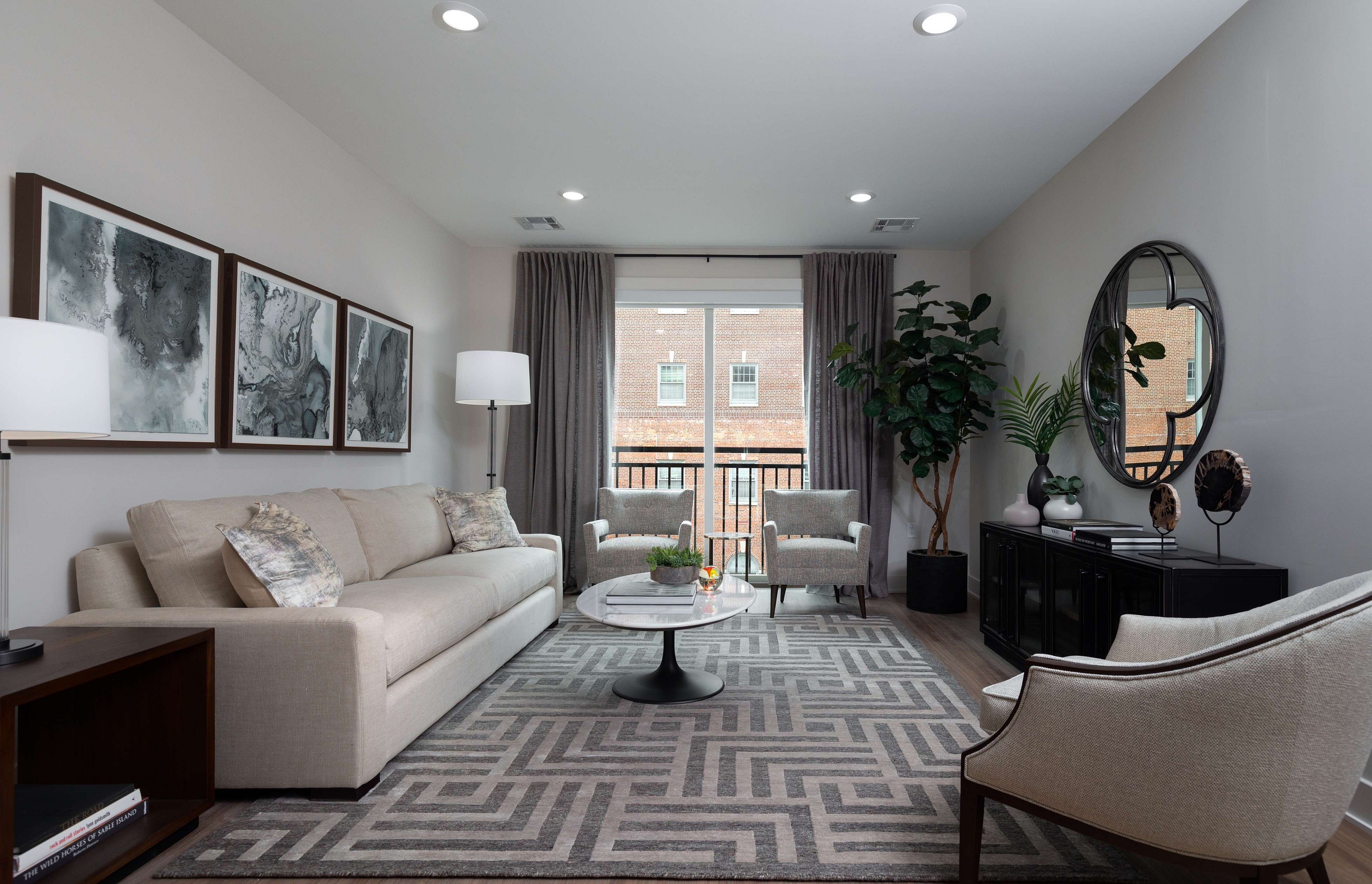 Chic living room with a neutral sofa, abstract art, and elegant decor.