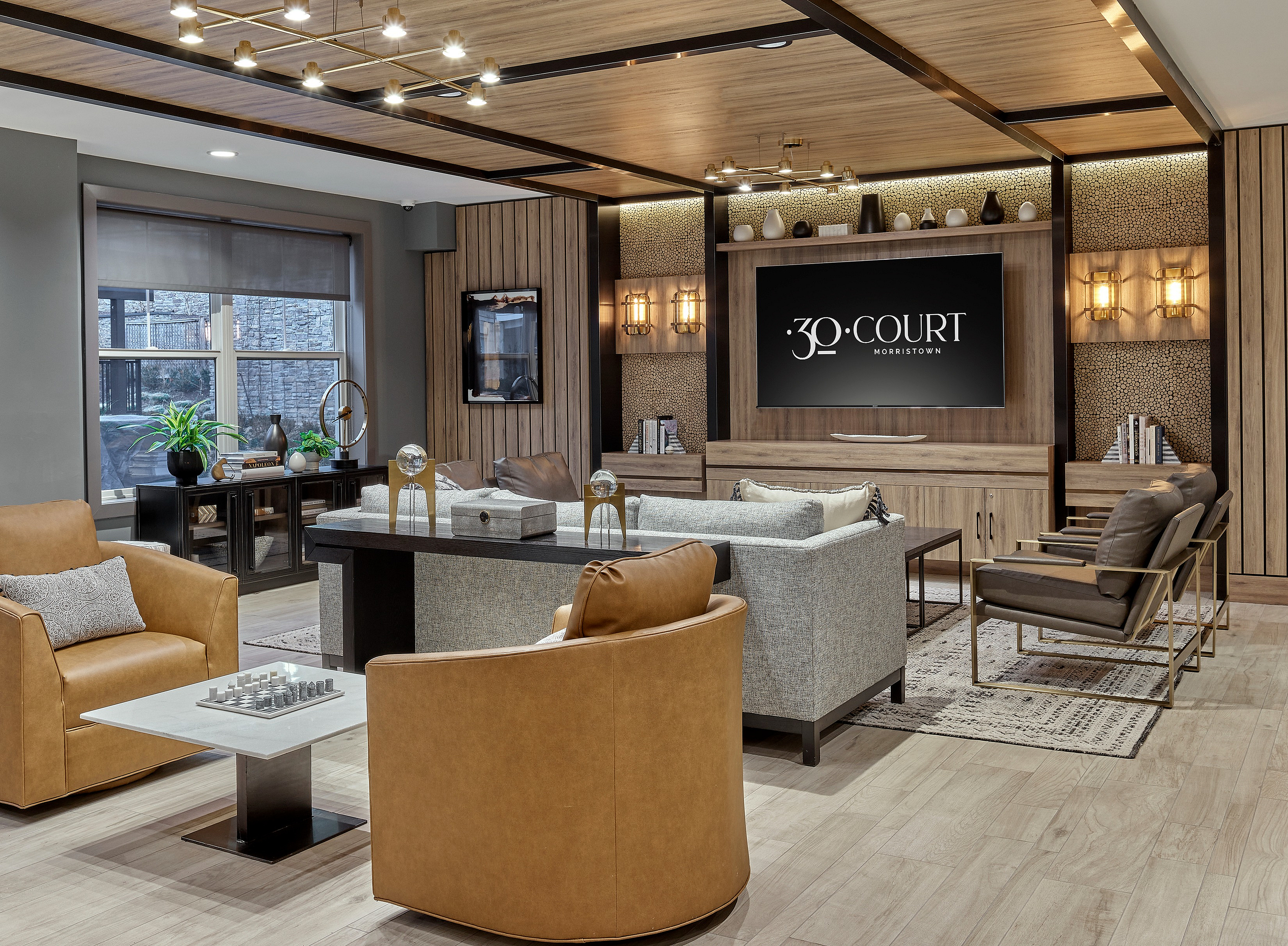 Sophisticated lounge area with modern furnishings, ambient lighting, and a sleek entertainment unit at 30 Court Morristown.