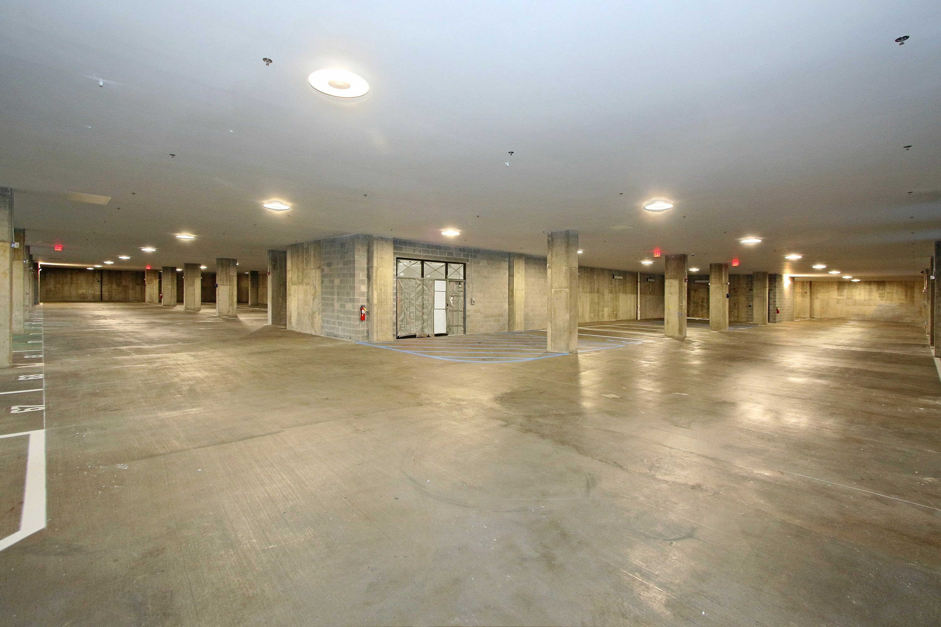 Expansive underground parking facility with ample space and modern lighting.