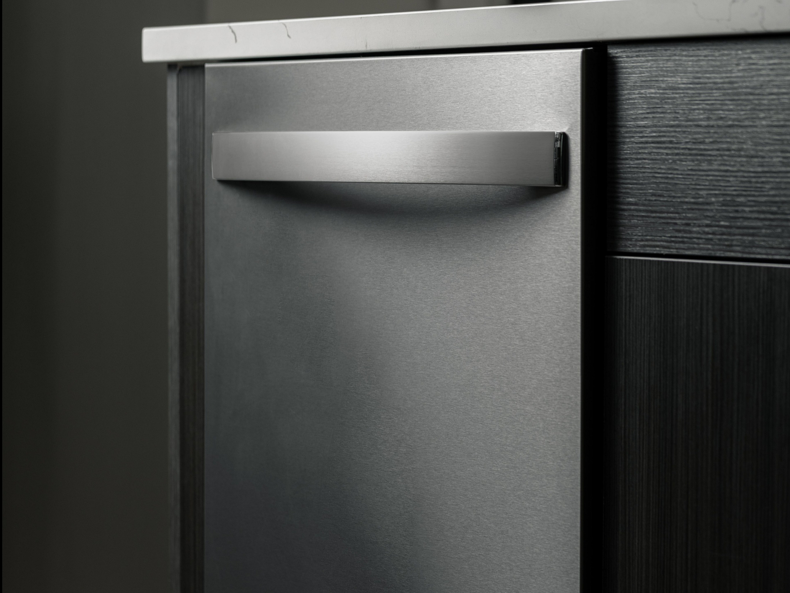 Sleek stainless steel dishwasher integrated into a modern kitchen design.