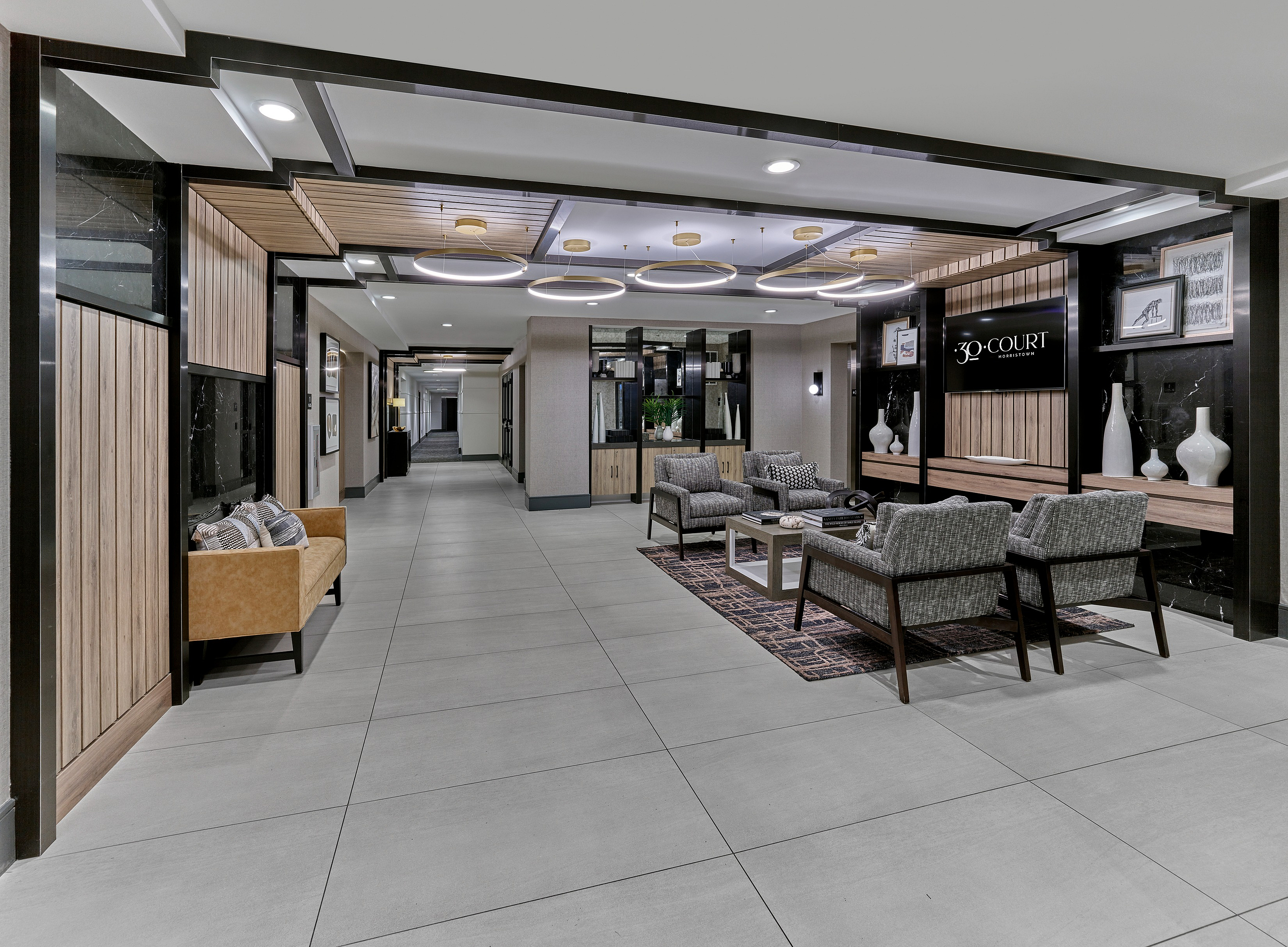 Luxurious apartment lobby with modern seating, elegant lighting, and sophisticated decor at 30 Court.