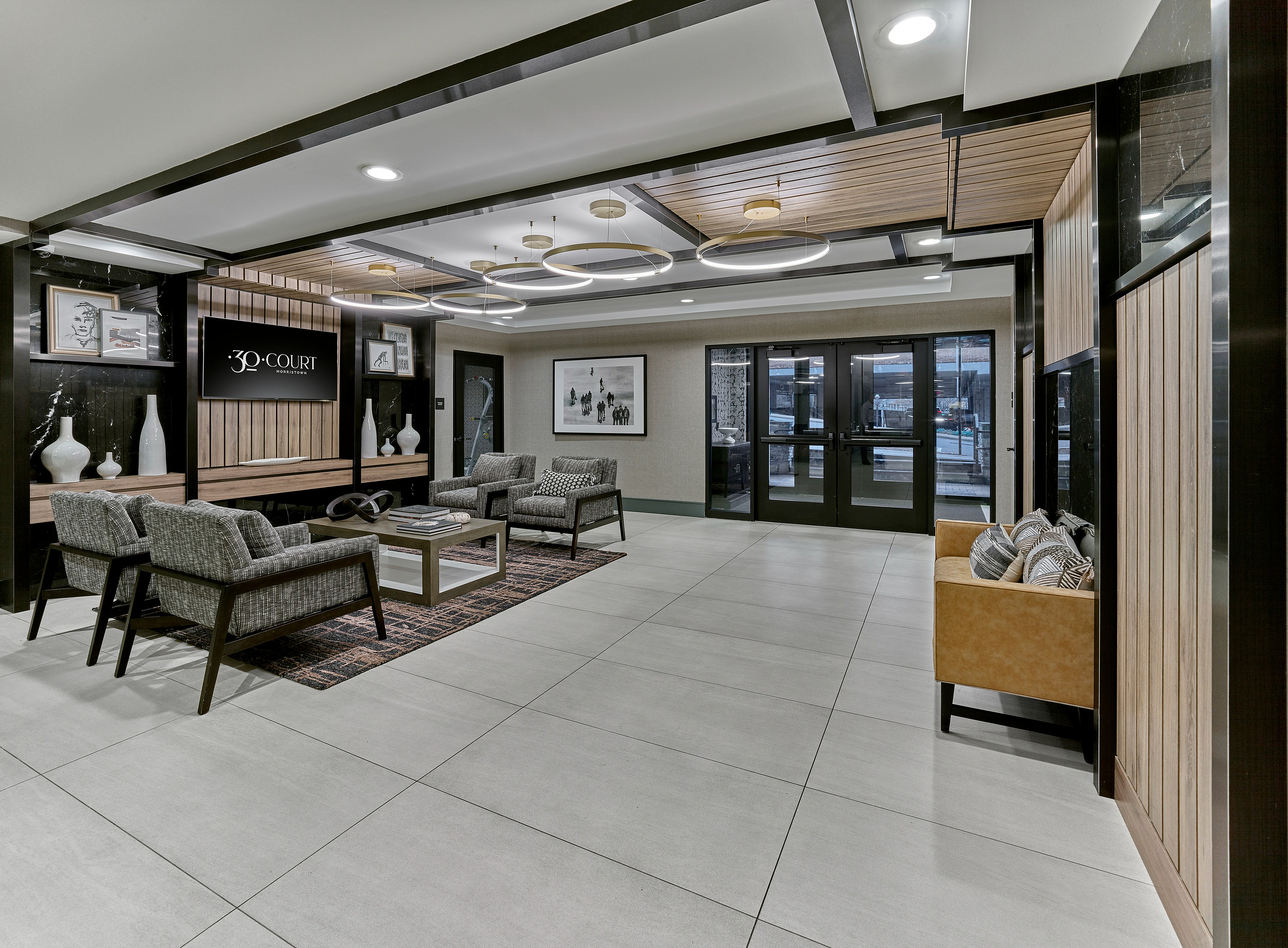 Elegant apartment lobby at 30 Court, featuring modern seating, chic lighting, and sleek decor.