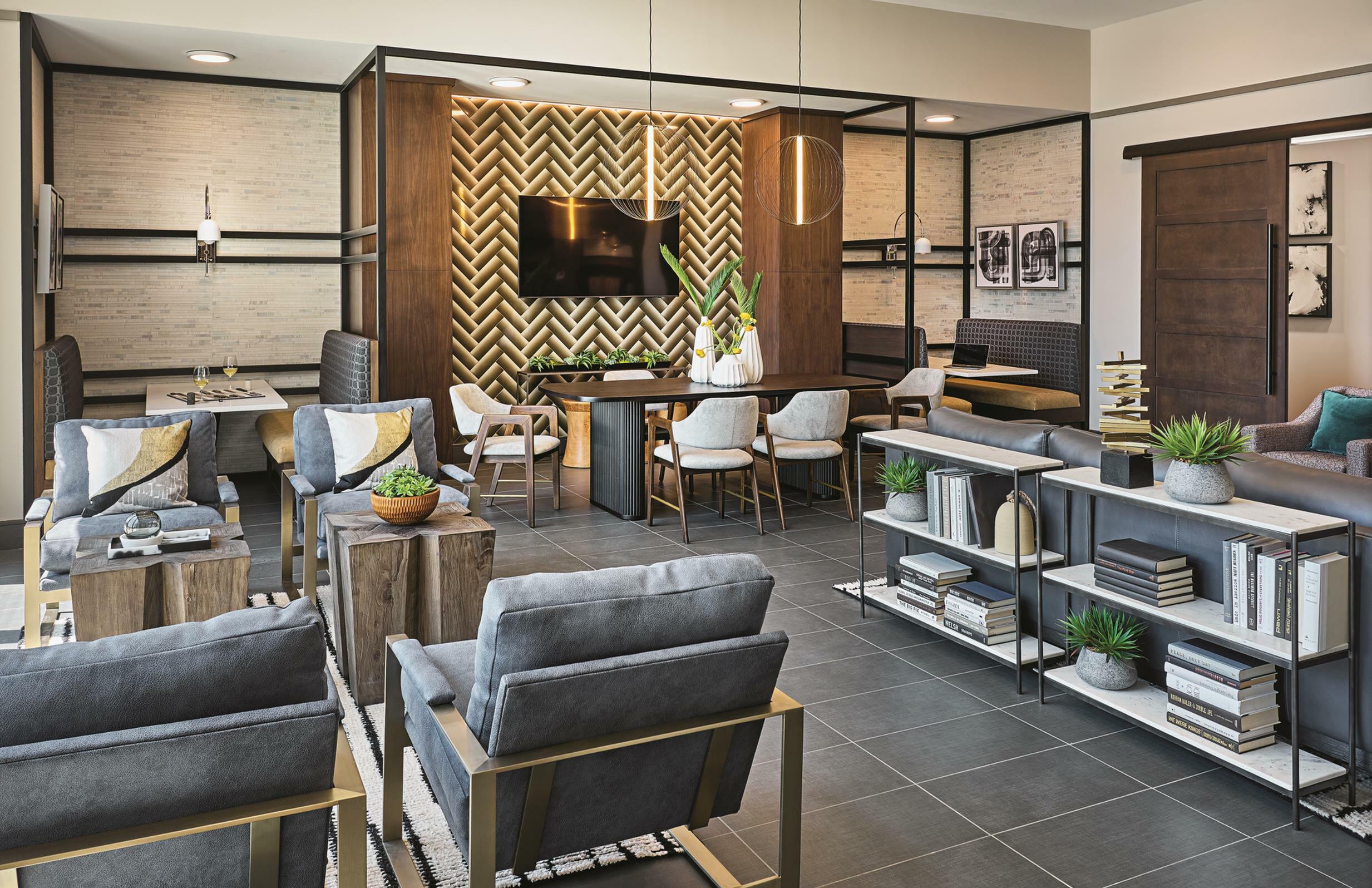 Elegant living space featuring modern decor, plush seating, open dining area, and stylish shelving in a luxurious apartment.