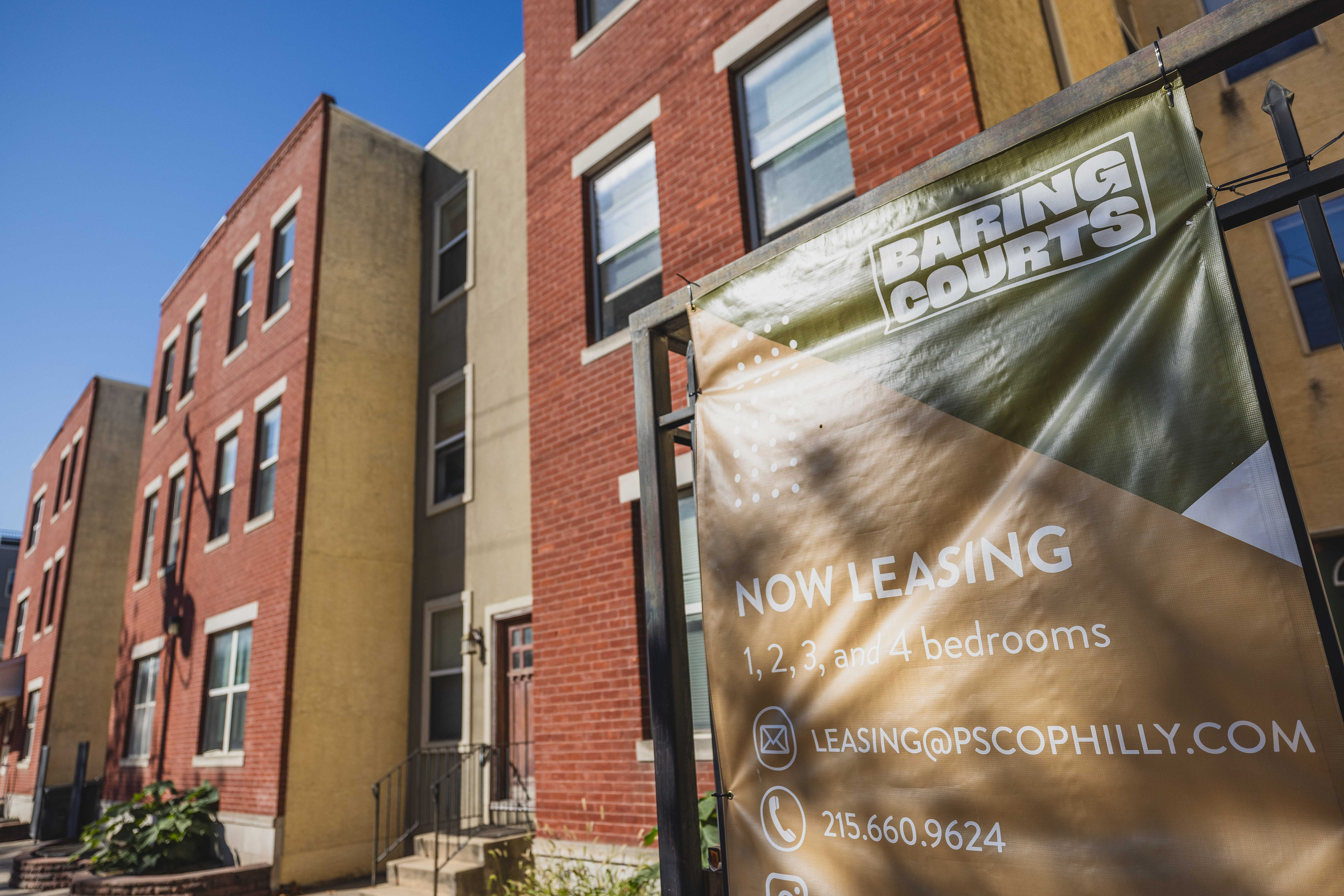 Charming urban apartment building with red brick exterior, offering 1 to 4 bedroom options, now leasing at Baring Courts.
