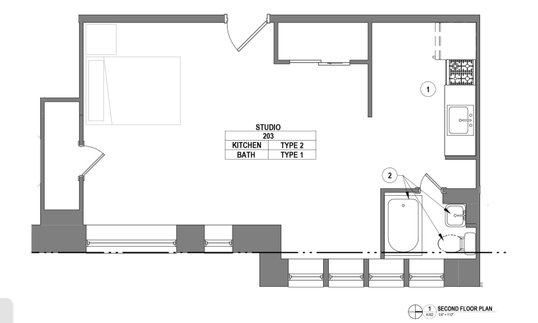 Sleek studio apartment floor plan with open kitchen and compact bathroom layout, showcasing efficient use of space.