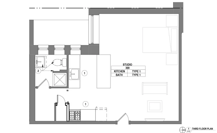 Modern studio floor plan featuring an efficient layout with a combined living and sleeping area, a well-appointed kitchen, and a compact bathroom on the third floor.