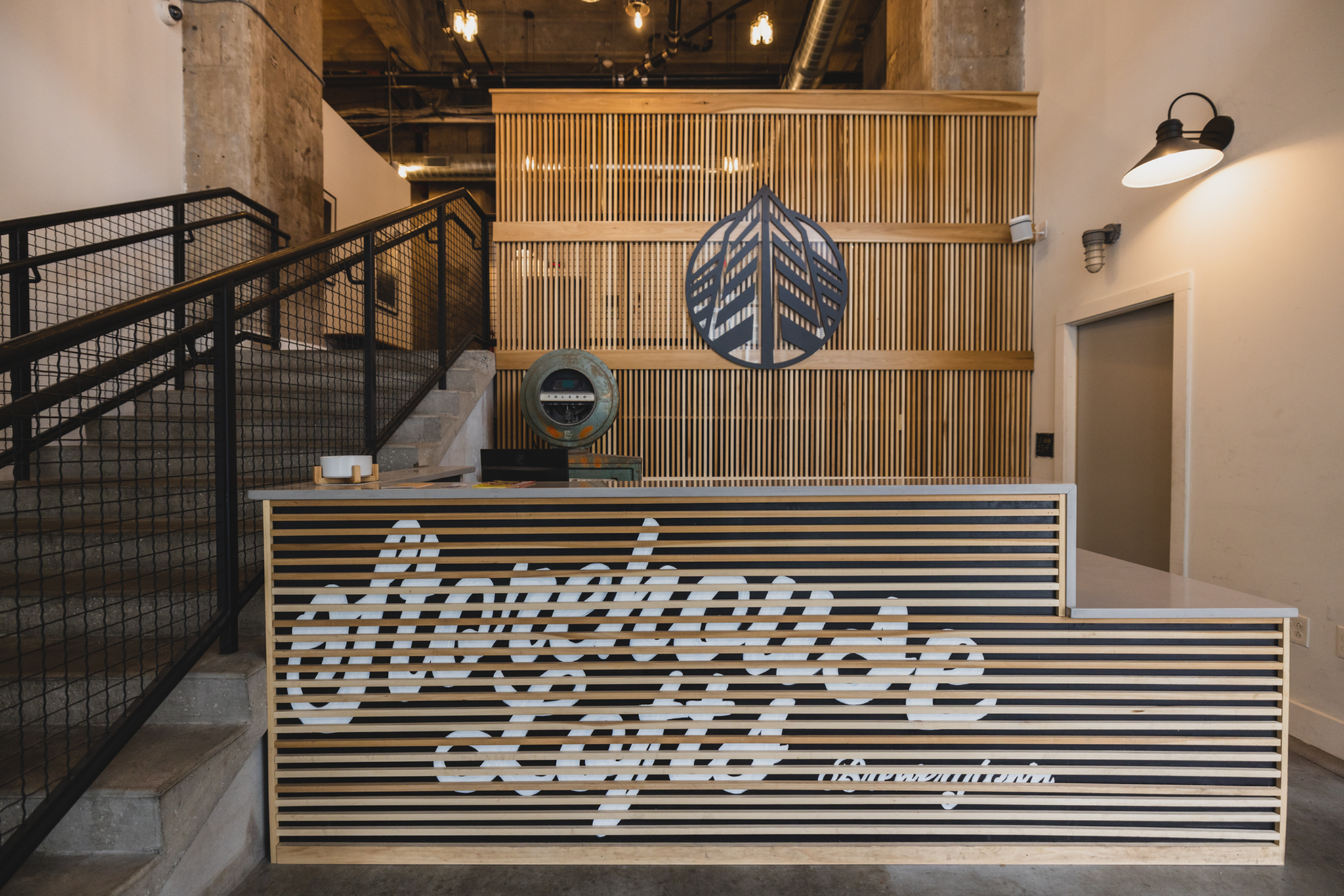 Chic industrial-style lobby with modern wooden slat design at Warehouse Lofts.
