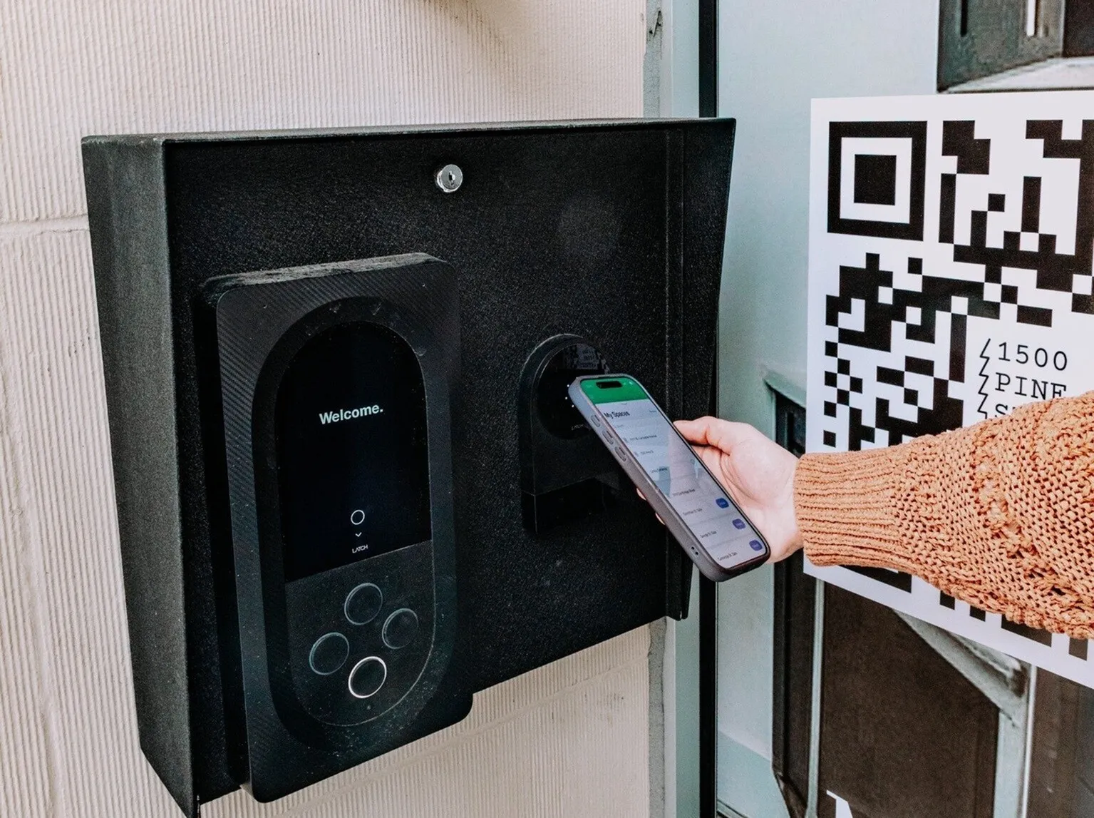 Modern apartment entry with smart access system, featuring a sleek digital interface and convenient mobile phone integration.