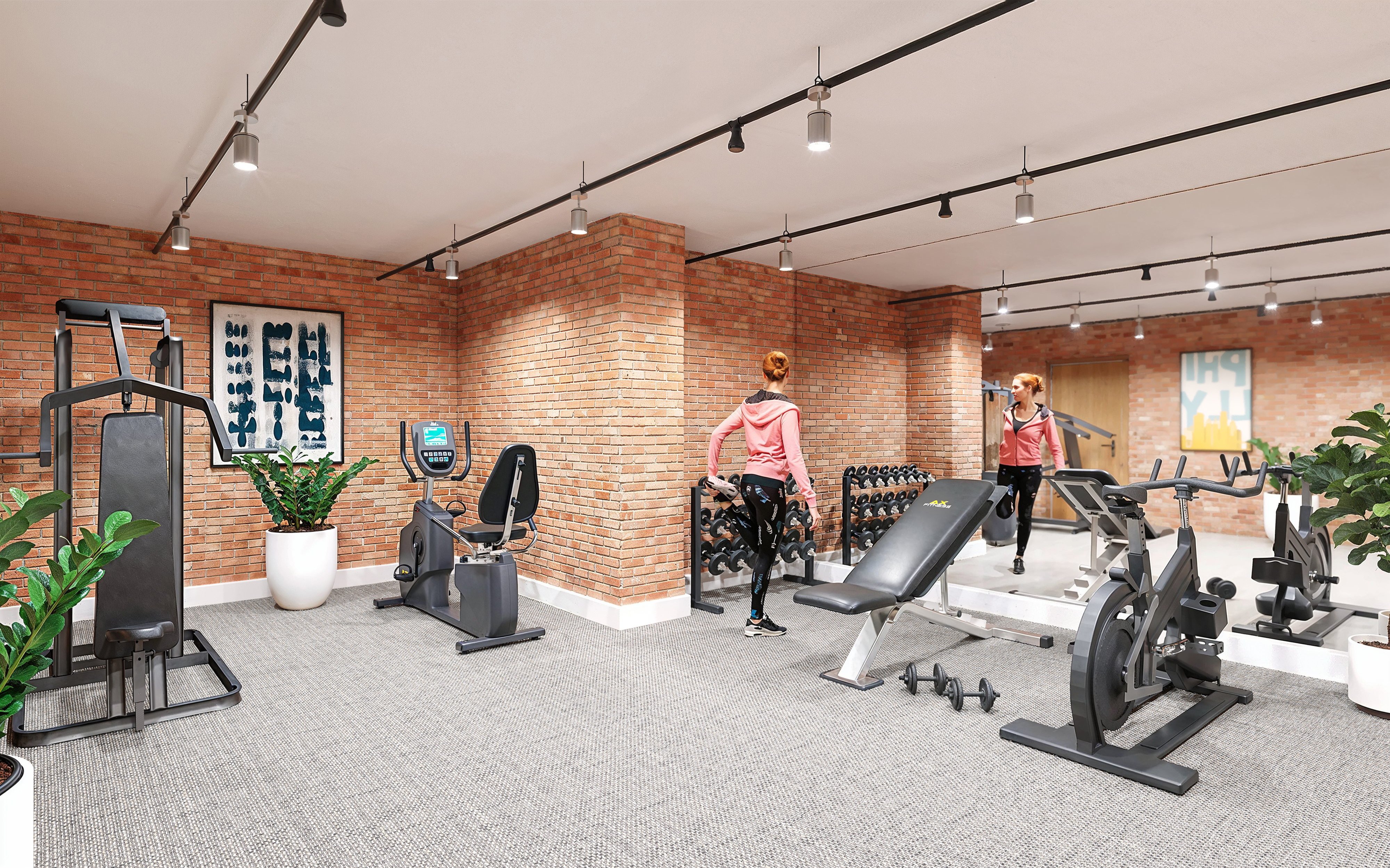 Vibrant fitness center with state-of-the-art gym equipment, free weights, and modern decor against brick walls.