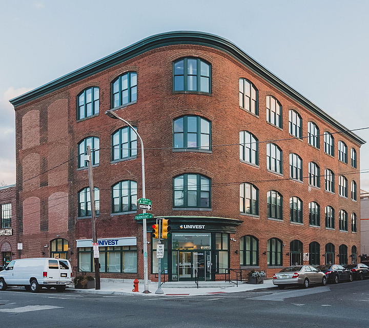 Charming corner of AF Bornot building with large arched windows, promising modern urban living in a historical facade.