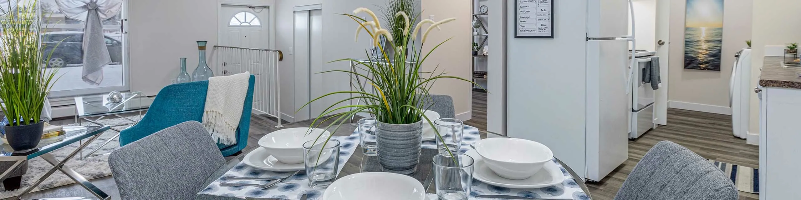Modern and inviting open-concept dining room with elegant table setting, cozy living area, and stylish decor.