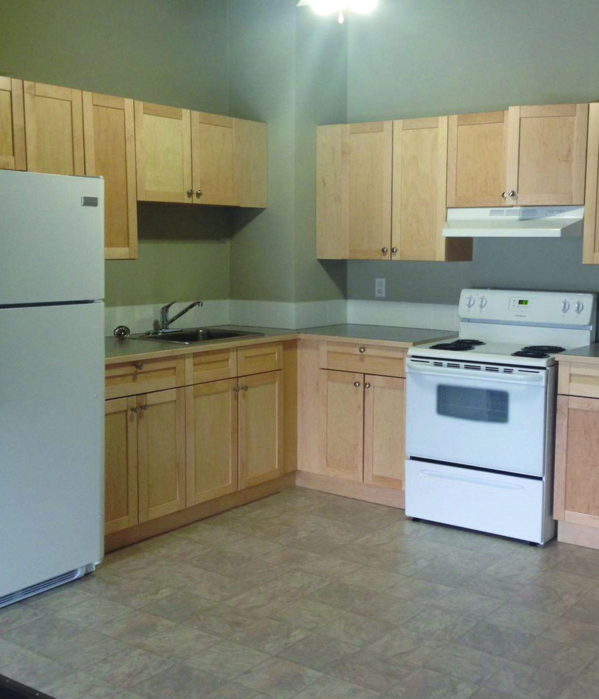 Inviting kitchen with warm wood cabinets, modern appliances, and ample counter space.