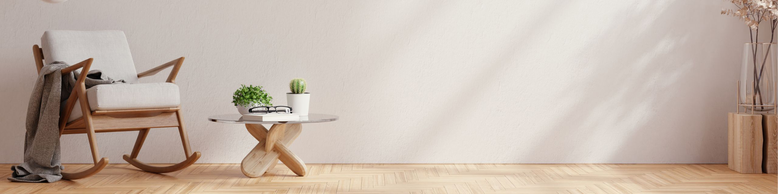 Elegant minimalist nook with a cozy rocking chair, chic glass-top table, and stylish decor in natural light.