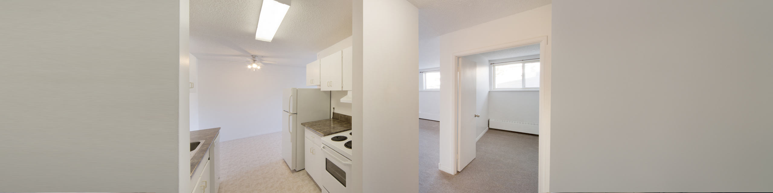 Bright and airy kitchen in an open layout apartment, featuring modern appliances and clean lines.