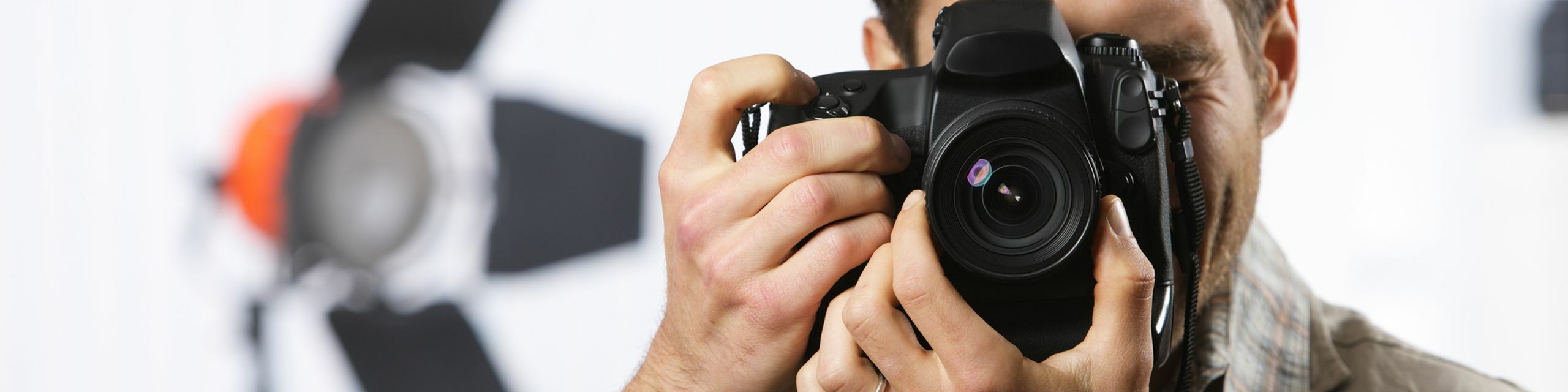 Close-up of a camera lens with warm sunlight creating an artistic flair, highlighting professional photography.