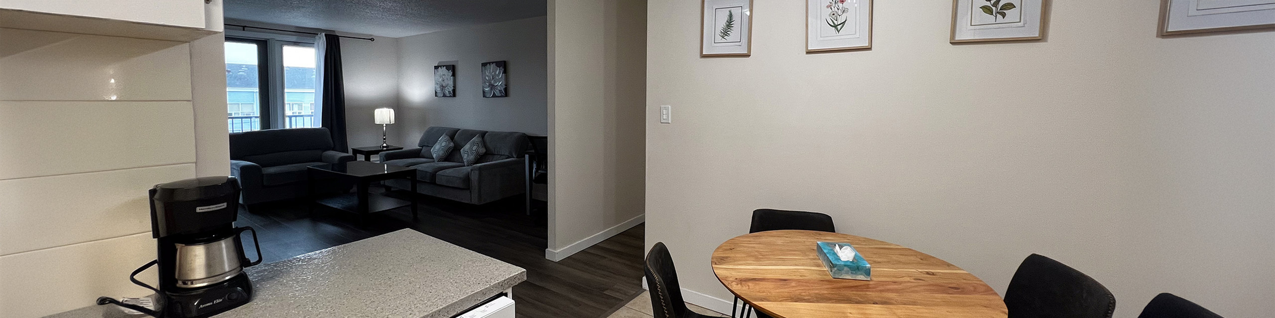 Cozy apartment interior featuring a modern living room with plush sofas, an inviting dining area with a round wooden table, and stylish decor accents.