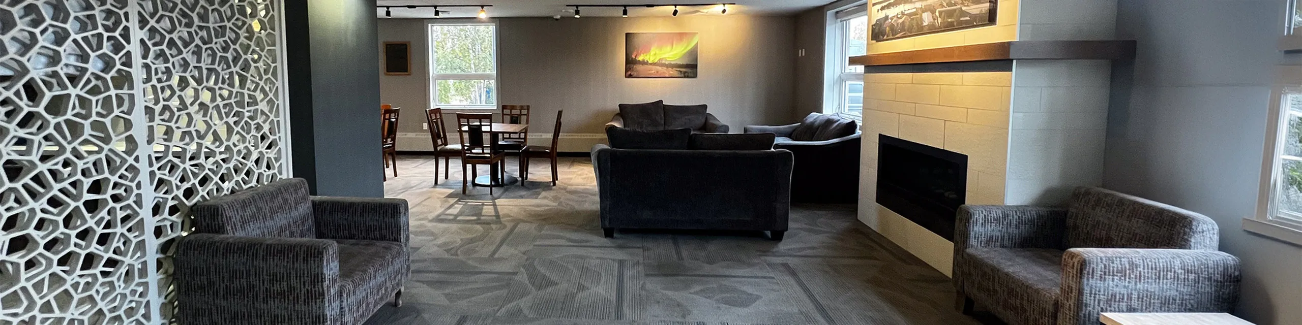 Inviting living room featuring chic furniture, modern art, and a cozy fireplace, perfect for relaxation and gatherings.