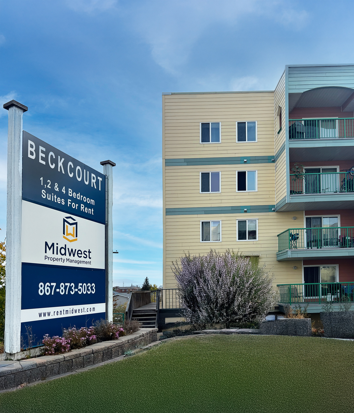 Inviting apartment complex with vibrant exterior and lush landscaping at Beckcourt, offering 1, 2, and 4 bedroom suites for rent.