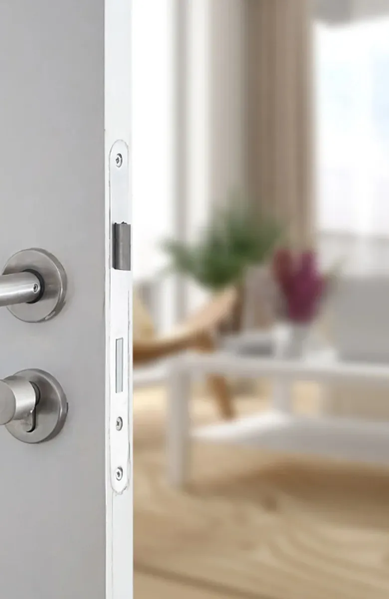 Inviting interior view with modern decor glimpsed through a sleek, stylish door ajar.