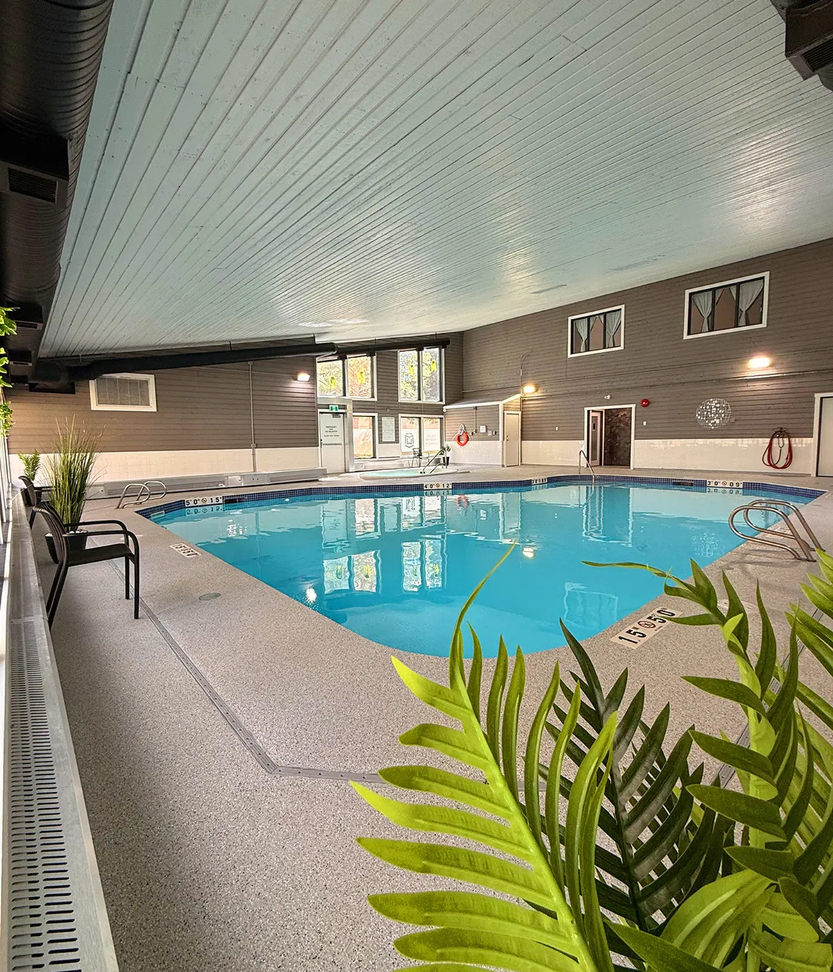 Inviting indoor swimming pool with modern design and natural light, perfect for year-round relaxation.