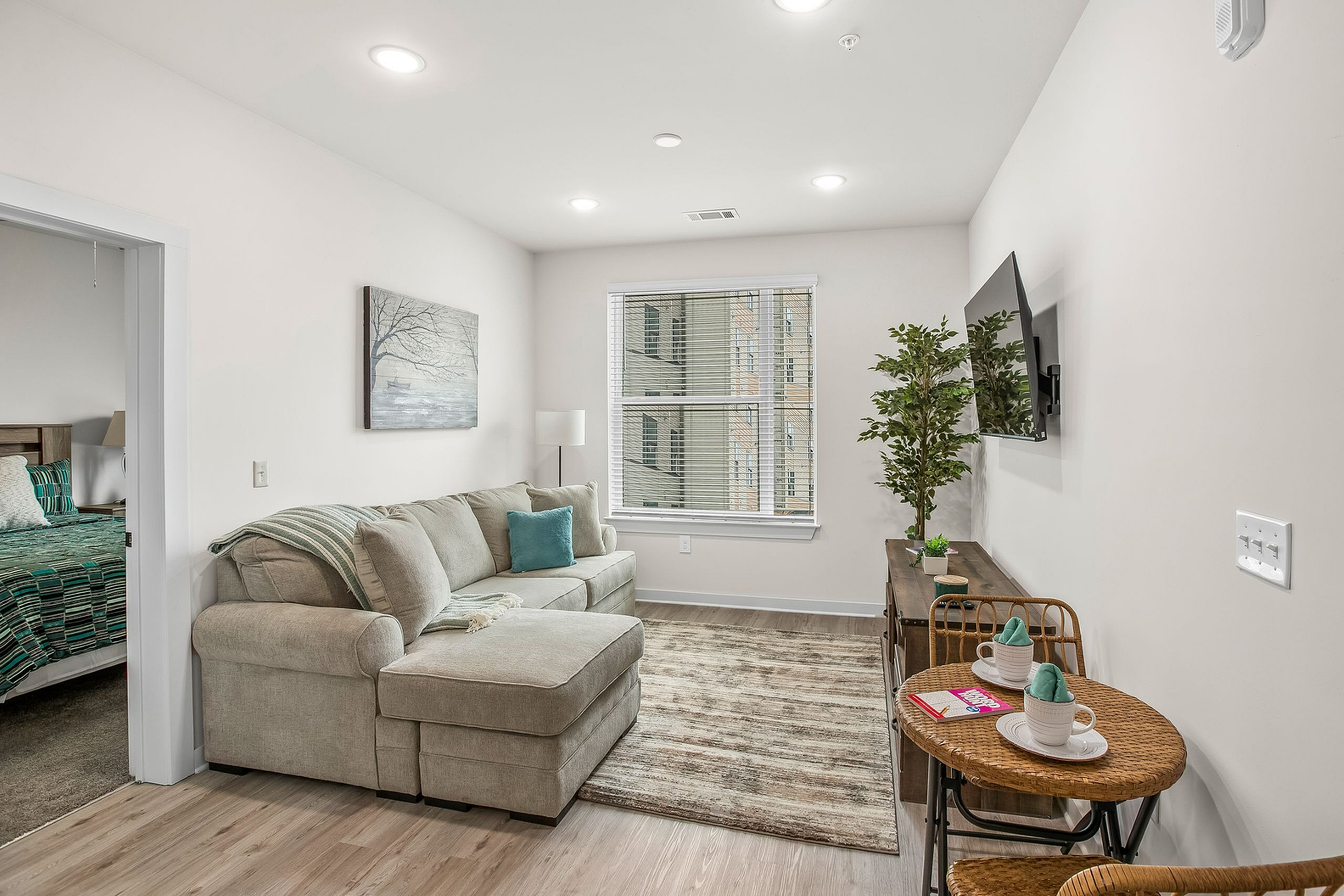 Cozy living room with a plush sectional sofa, vibrant pillows, and a modern TV setup for ultimate relaxation.