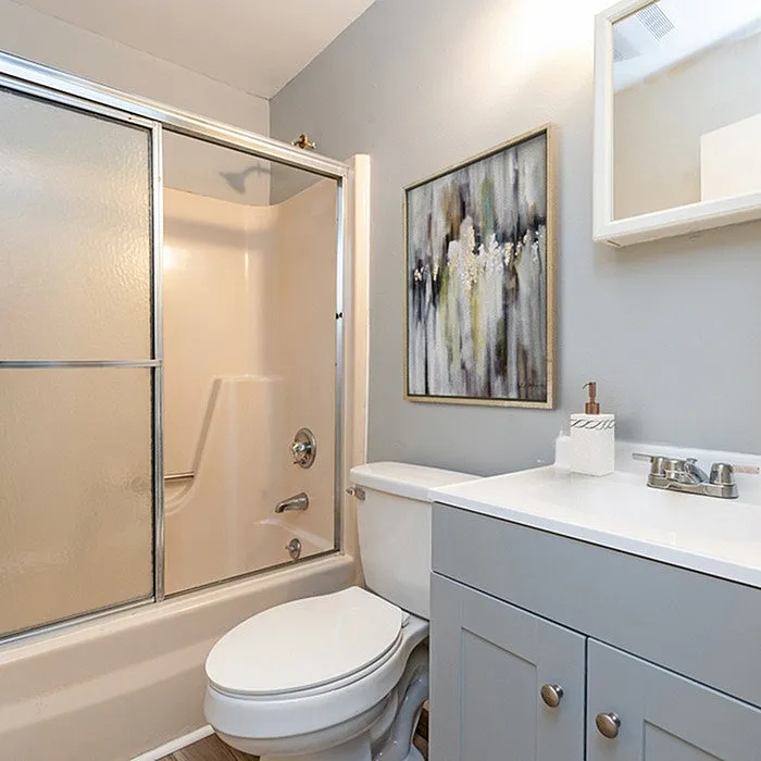 Elegant bathroom featuring a sleek vanity, modern shower, and stylish wall art.