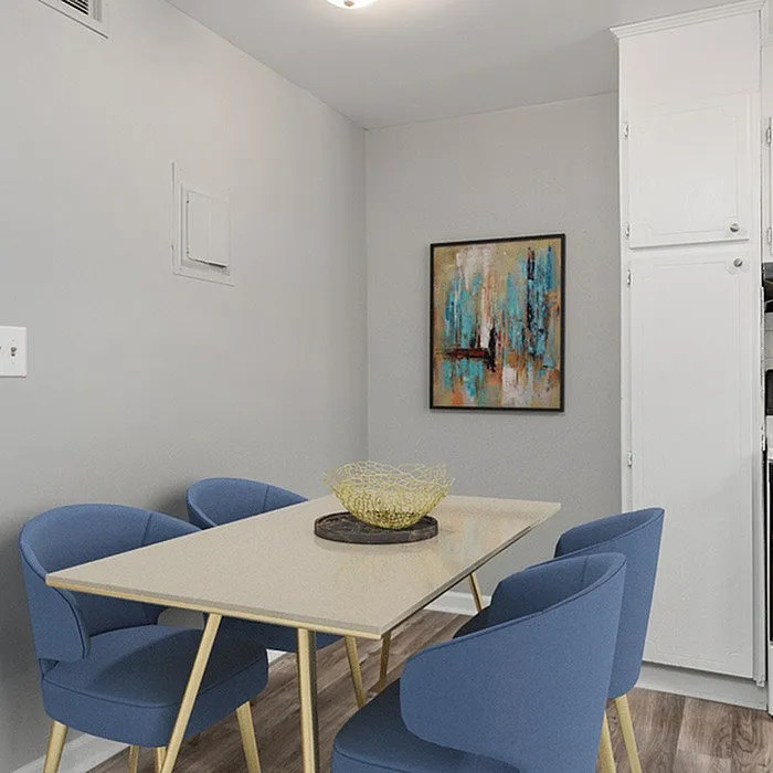 Elegant dining area with a modern table, four blue chairs, contemporary art, and stylish decor.