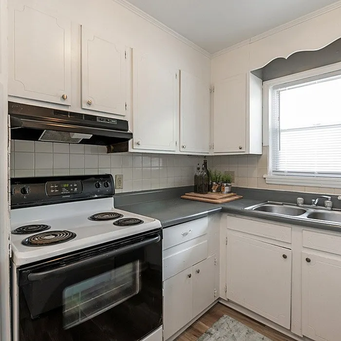 Cozy kitchen featuring white cabinets, modern appliances, and ample counter space with natural light.