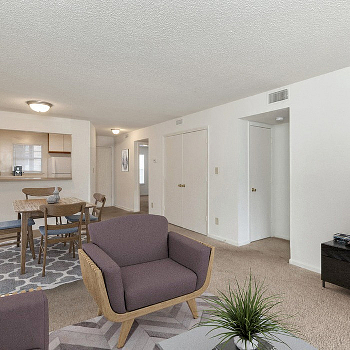 Modern open-plan living area featuring comfortable seating, a dining space, and a stylish kitchen.
