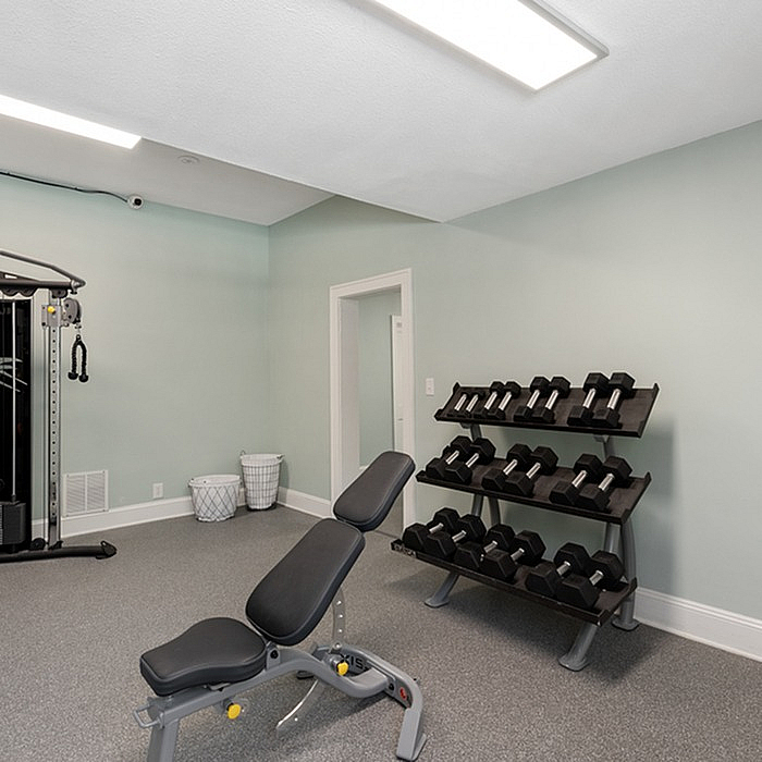 Contemporary home gym with modern equipment and sleek design.