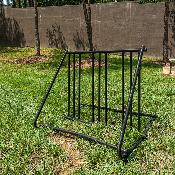 Inviting community space featuring a sleek bike rack surrounded by lush greenery, perfect for outdoor enthusiasts.