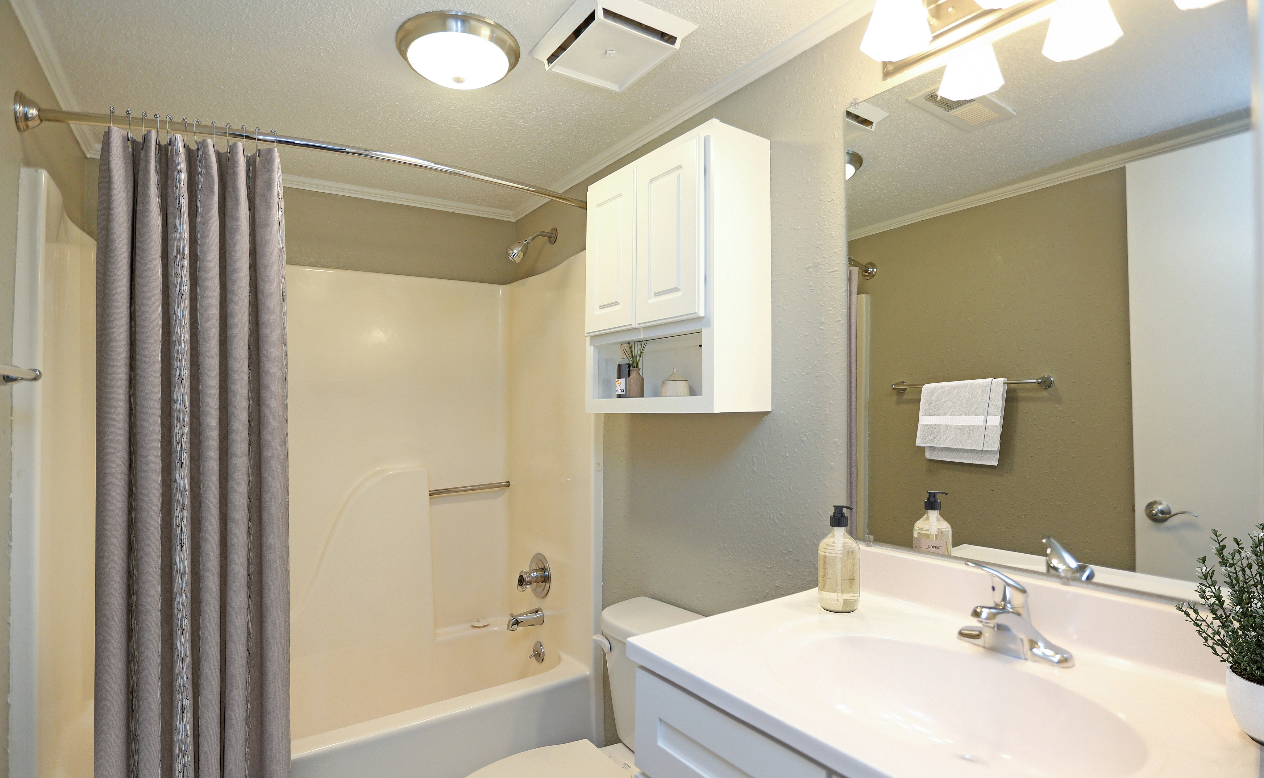 Bright and inviting bathroom with modern fixtures, stylish vanity, and elegant neutral decor.