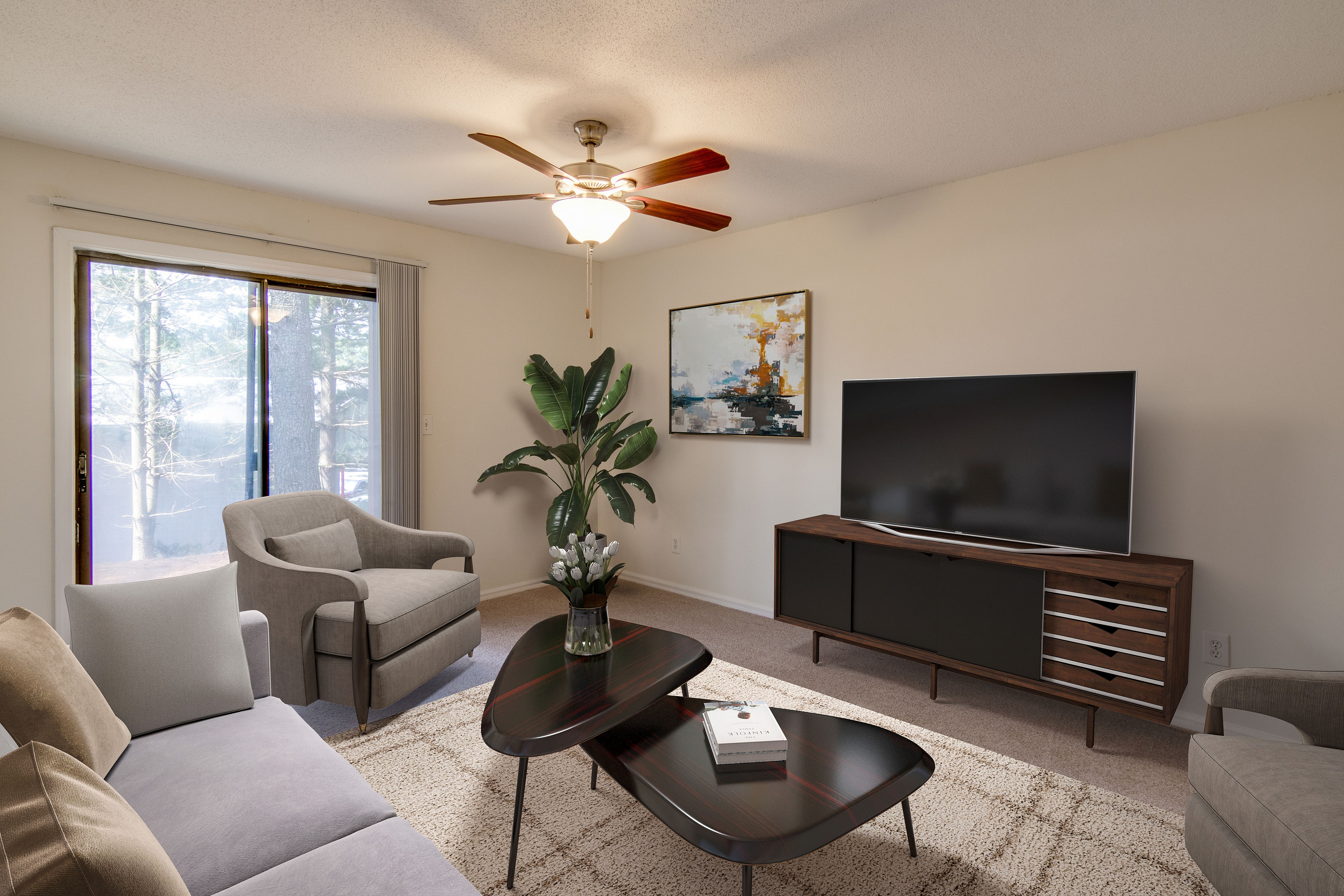 Inviting living room featuring elegant furniture, stylish decor, and a large TV, with natural light streaming through sliding glass doors.