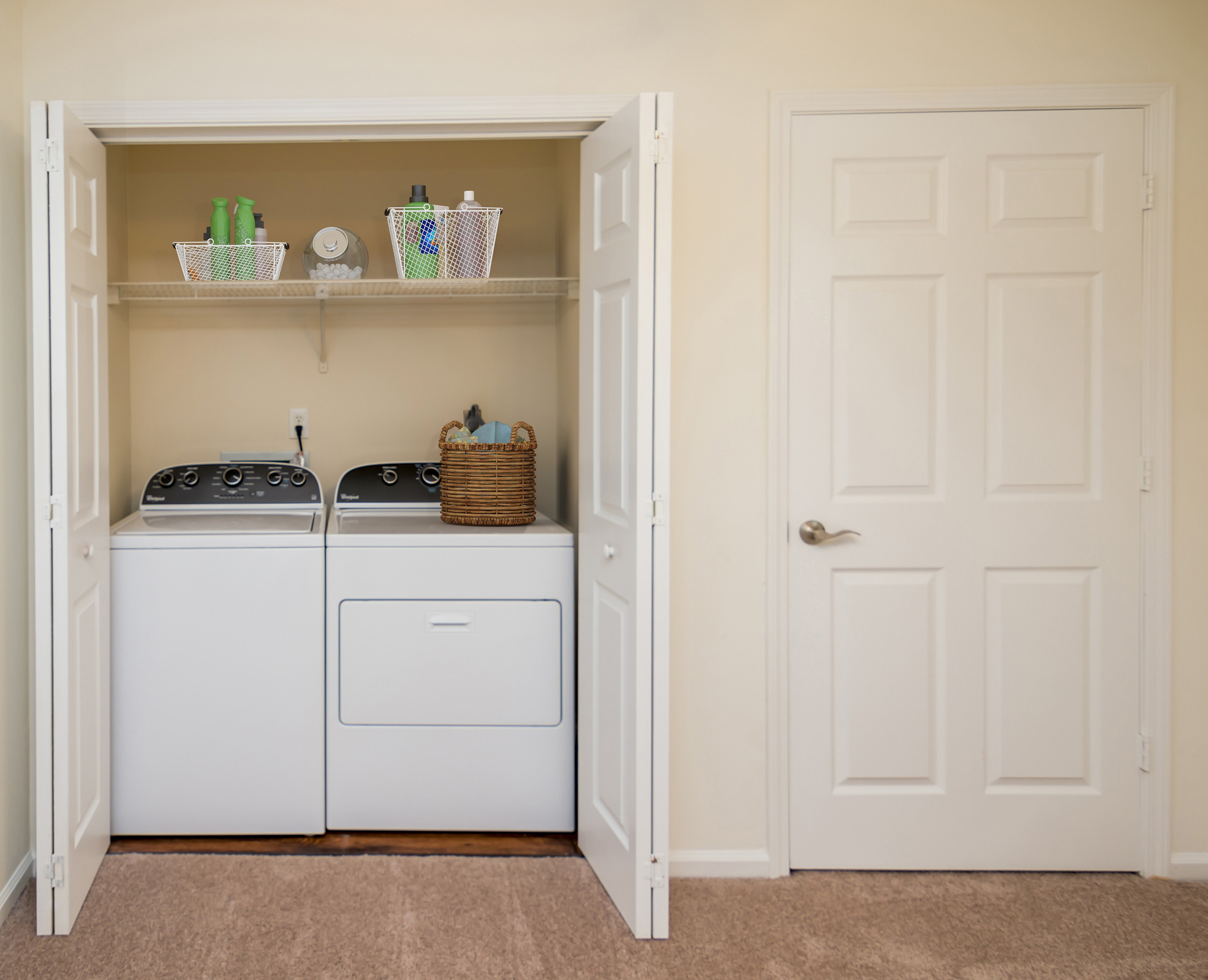 Chic and efficient laundry space with modern washer and dryer, ample storage for a tidy home.