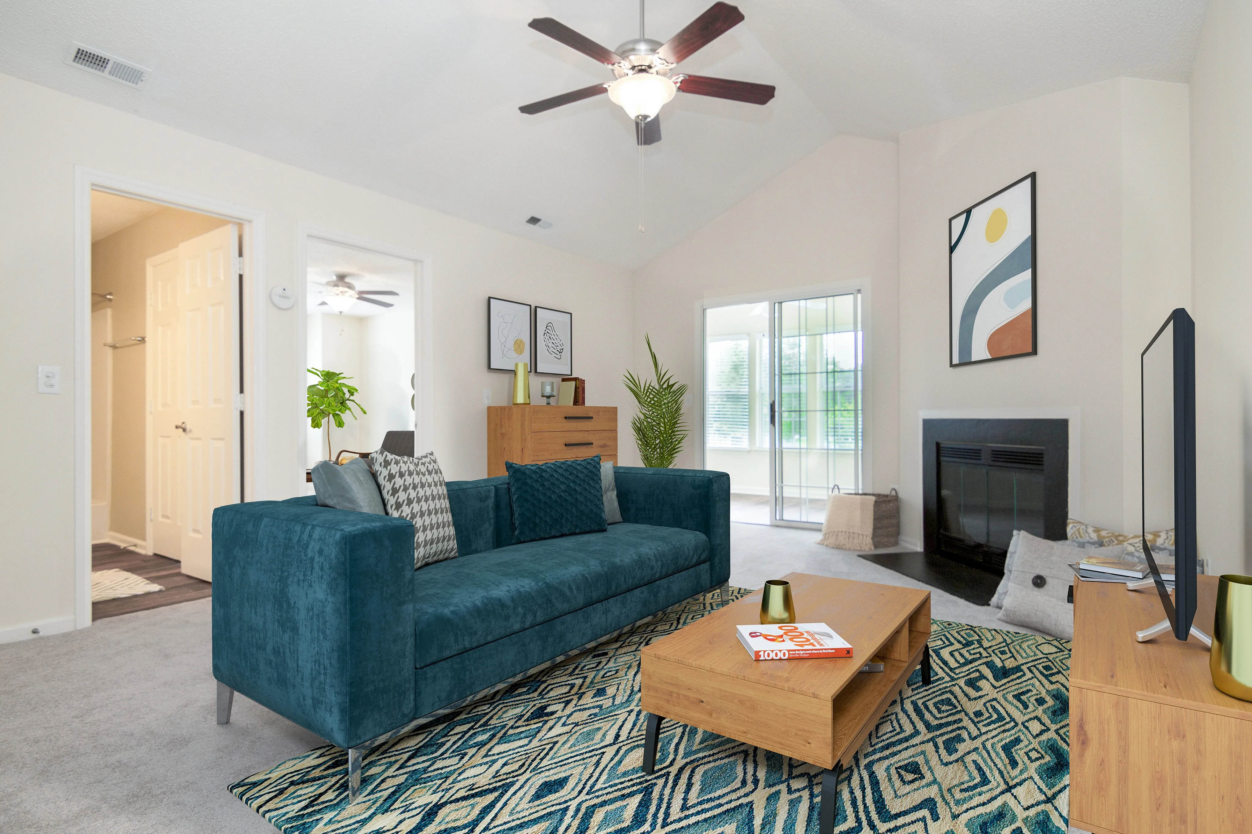 Inviting living room with vibrant teal sofa, modern art, and cozy fireplace, perfect for relaxation and entertaining.
