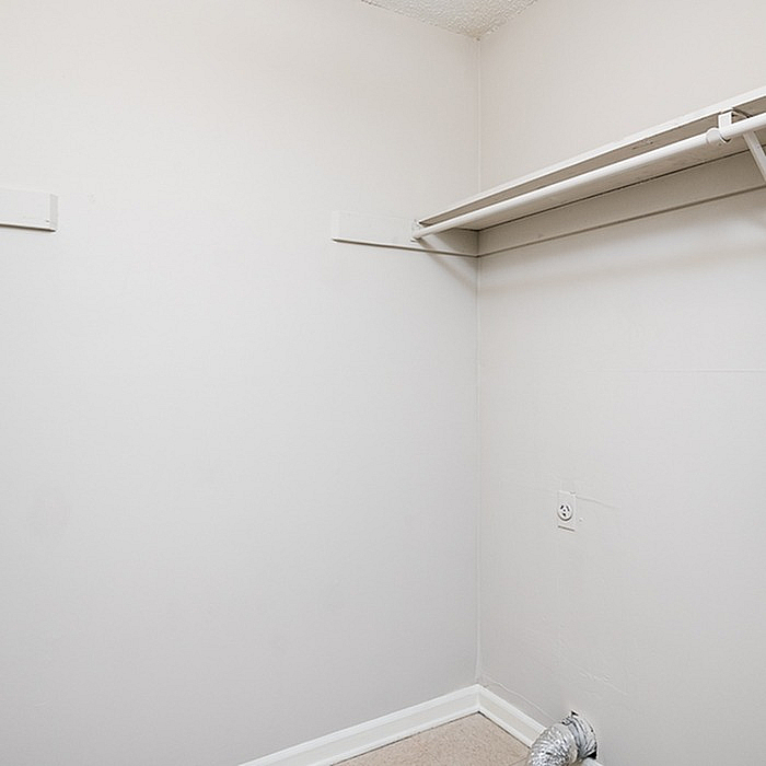 Bright and spacious closet area with ample shelving, perfect for organized storage.