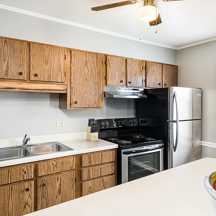 Charming kitchen featuring stainless steel appliances, rich wooden cabinetry, and a spacious countertop perfect for culinary creations.