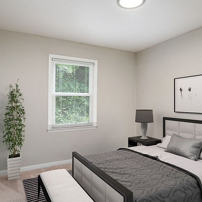Inviting bedroom with modern furniture, elegant decor, and a sunlit window offering soothing natural views.