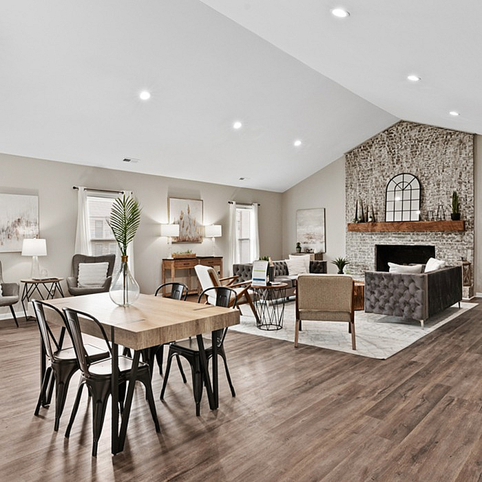 Elegant open-concept living and dining area with stylish decor, cozy fireplace, and modern furnishings, perfect for entertaining.