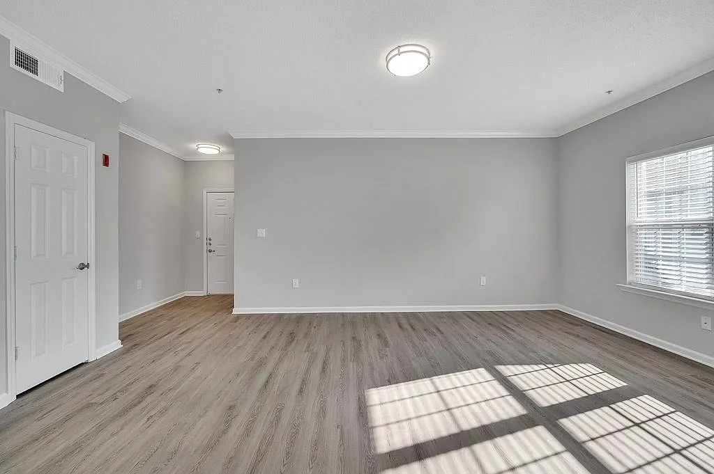 Bright and inviting living space with elegant hardwood floors and ample natural light.