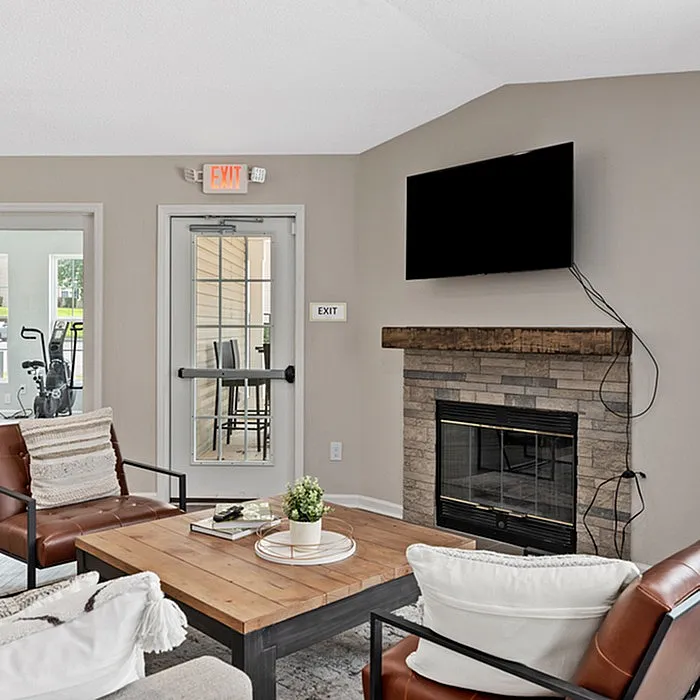 Inviting living room featuring a cozy fireplace, elegant seating, and a modern decor with a wall-mounted TV.
