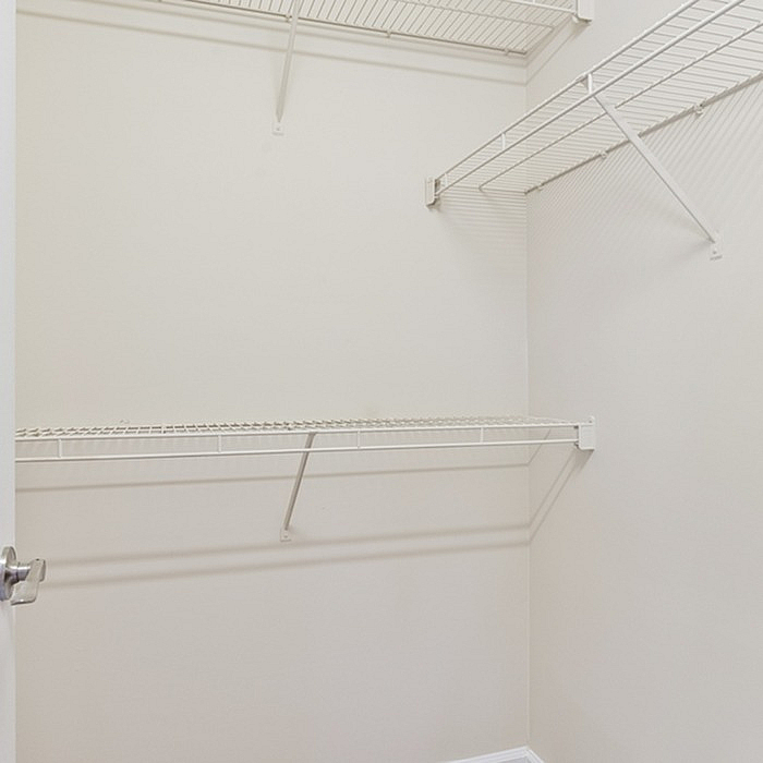 Spacious and versatile walk-in closet with sturdy wire shelves, ideal for organized storage and maximizing space.